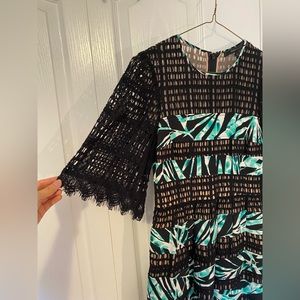 BCBG Maxazria designer cocktail dress with lace sleeves and mesh - size 0